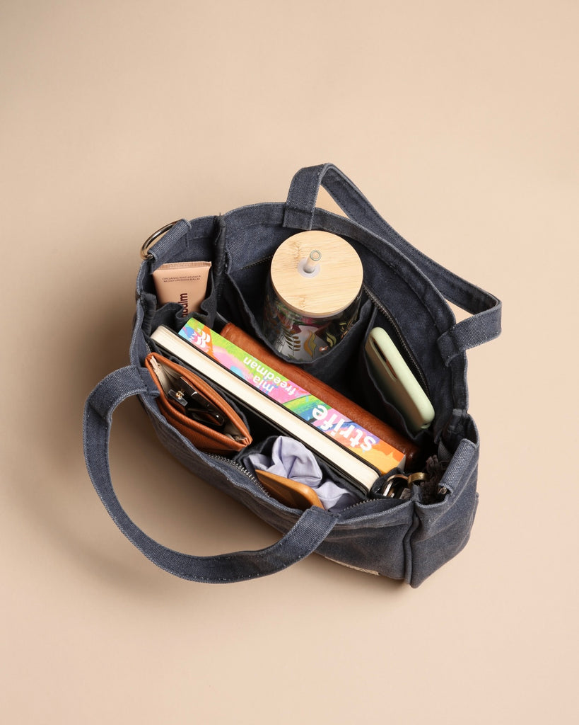 Smaller version of the bestselling everyday zip top pocket tote, with six internal pockets, in a versatile and casual style. The perfect bag for days when you don’t need to carry everything.